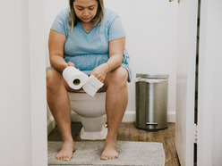 Pregnant woman checking the time on her phone