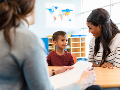 child with parent and teacher